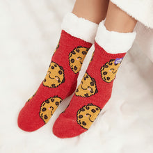 Load image into Gallery viewer, The Foozie™ Cookie Red slipper socks, smiling cookie print on red, worn on a fluffy white rug